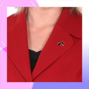 Cat Pin with Black & Gold Enamels modelled on red jacket lapel
