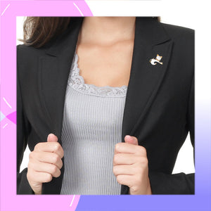 Cat with Gold and White Enamel Brooch modelled on the lapel of a dark grey jacket