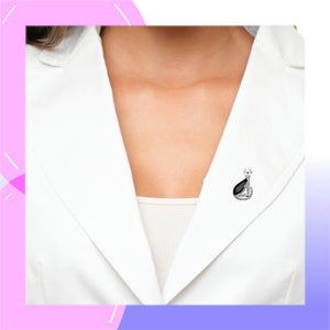 Cat Sterling Silver with Marcasite & Cubic Zirconia Brooch displayed by a model in a white jacket