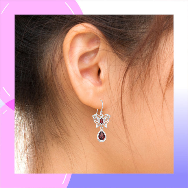 Butterfly Sterling Silver dangle Earrings with Garnet modelled